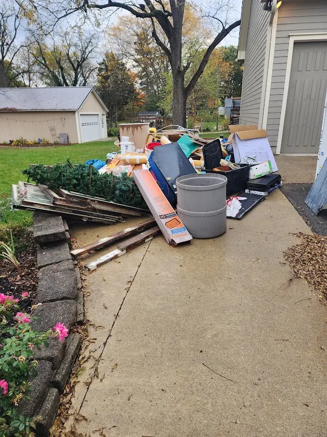 Dumpster being loaded with debris for 3 Yard Dumpster Rental in Medfield